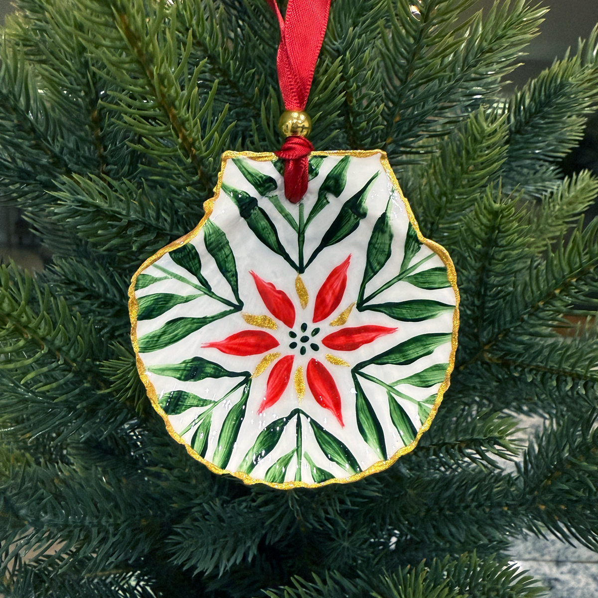 Decorative Christmas ornament with red and green design on a tree