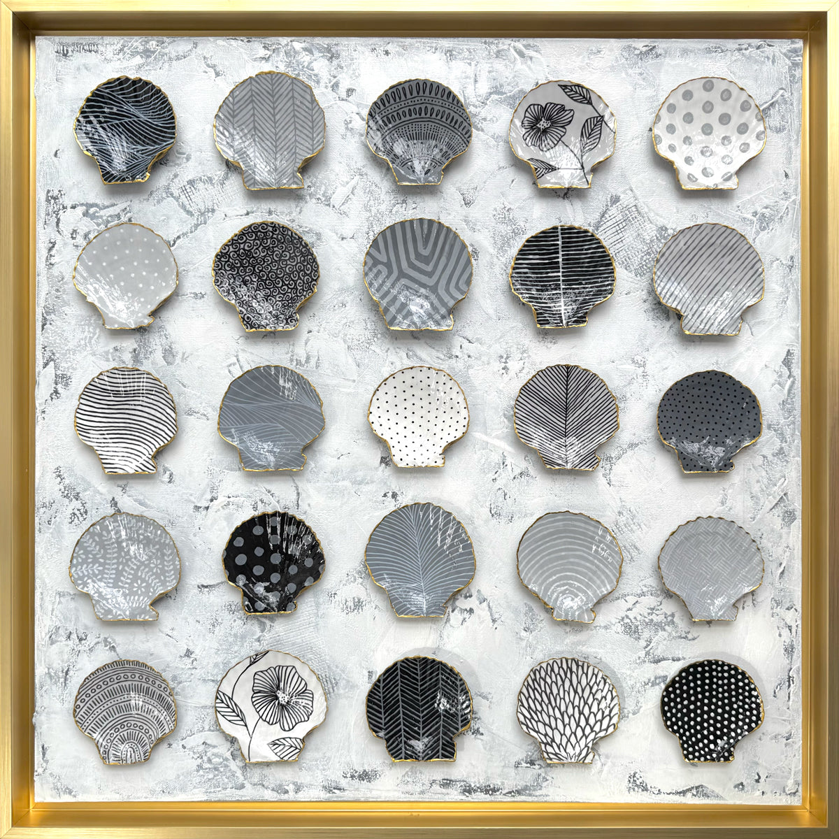 Decorative wall art with shell-shaped plates in a gold frame. ©DoraKnuteson