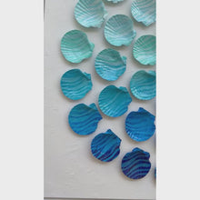 Load and play video in Gallery viewer, Deep Blue Drift by Dora Knuteson-Artistic arrangement of blue and green seashells on a white background
